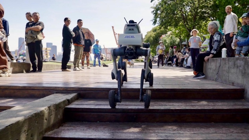 A patrol robot dog climbing steps in a mixed pedestrian area, handling unstructured terrain without a pre-built map.